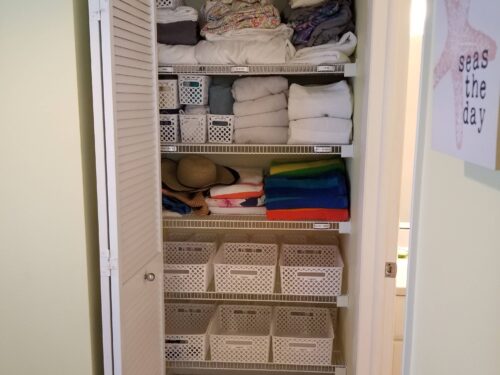 Organized linen closet with neatly stacked towels and bedding, reflecting the orderly and luxurious accommodations at Marco Apollo 1001.