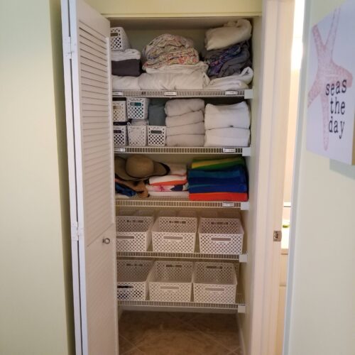 Organized linen closet with neatly stacked towels and bedding, reflecting the orderly and luxurious accommodations at Marco Apollo 1001.